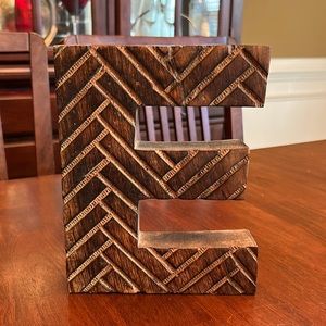 Beautiful wooden carved “E” letter